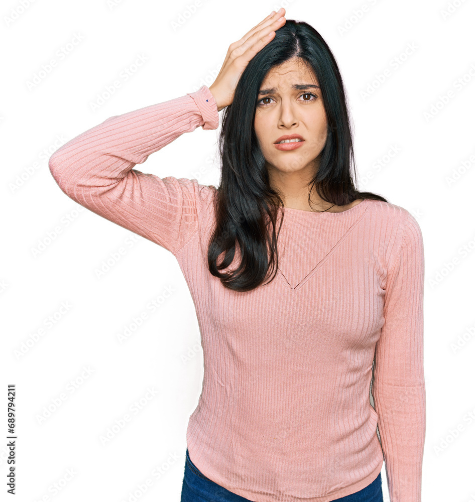 Young hispanic woman wearing casual clothes confuse and wonder about question. uncertain with doubt, thinking with hand on head. pensive concept. Young hispanic woman wearing casual clothes confuse and wonder about question. uncertain with doubt, thinking with hand on head. pensive concept.