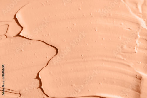 Peach color cosmetic, paint or clay texture close-up, abstract background