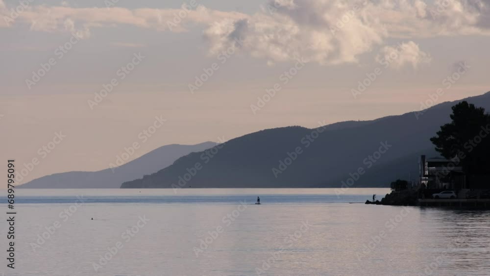 Seagull flying above the calm sea surface in a beautiful bay. Sunset time at the Mediterranean sea near Opatija, Croatia. Magnificent nature. Real time footage of a bird for background, intro or outro Seagull flying above the calm sea surface in a beautiful bay. Sunset time at the Mediterranean sea near Opatija, Croatia. Magnificent nature. Real time footage of a bird for background, intro or outro