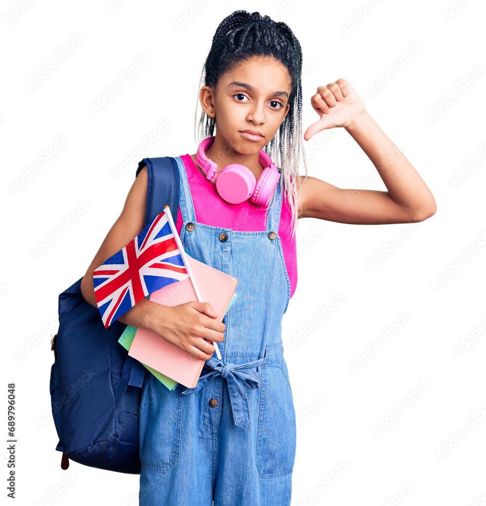 Cute african american girl wearing student backpack holding united kingdom flag with angry face, negative sign showing dislike with thumbs down, rejection concept Cute african american girl wearing student backpack holding united kingdom flag with angry face, negative sign showing dislike with thumbs down, rejection concept