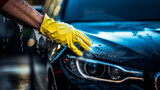 Close-up of hands washing a car