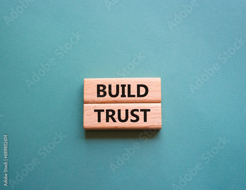 Build trust symbol. Wooden blocks with words Build trust. Beautiful grey green background. Business and Build trust concept. Copy space.