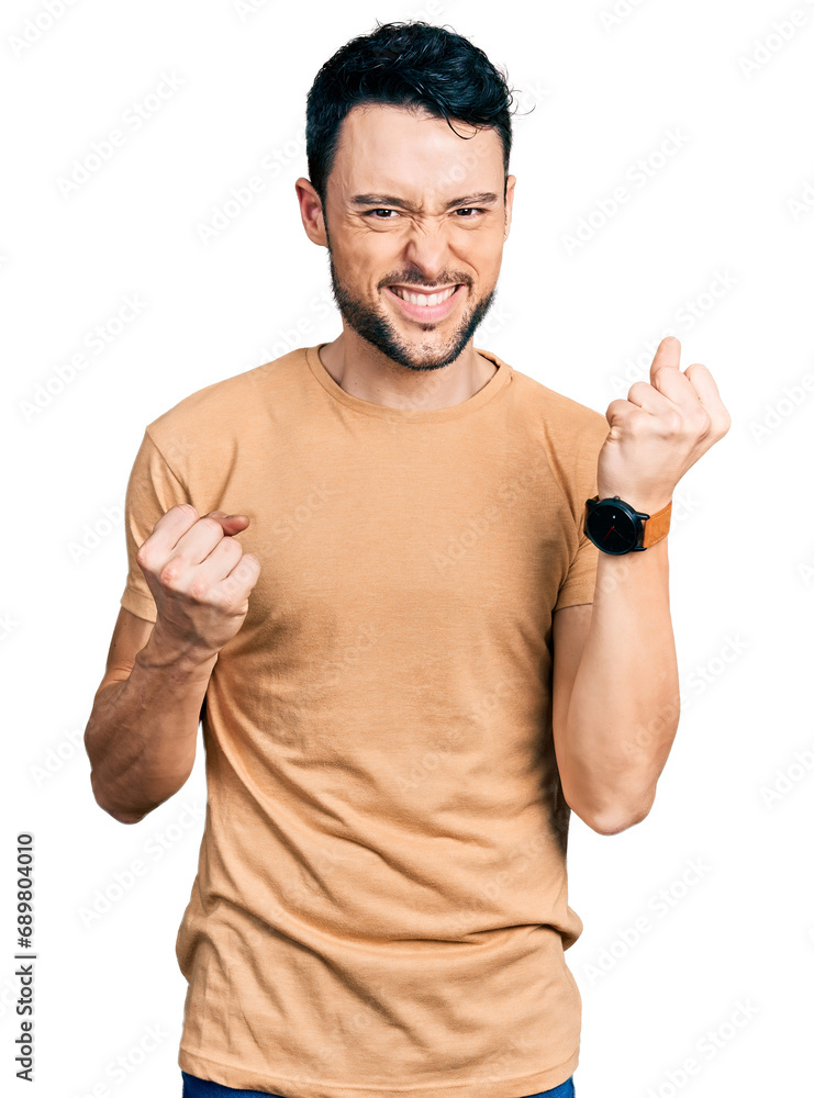 Hispanic man with beard wearing casual t shirt celebrating surprised and amazed for success with arms raised and eyes closed. winner concept. Hispanic man with beard wearing casual t shirt celebrating surprised and amazed for success with arms raised and eyes closed. winner concept.
