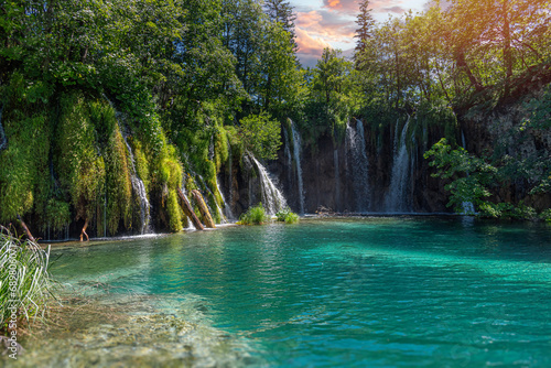 Fototapeta Naklejka Na Ścianę i Meble -  Picturesque waterfall. Waterfall among rocks and forest. Plitvice Lakes, Croatia.