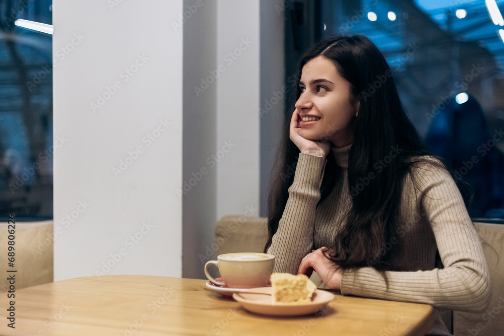 Pretty smiling young woman sitting in cafe, drink cup of coffee hot beverage, eating piece of creamy chocolate cake with nuts on plate, tasting dessert. Chill, relax, lunch
Pretty smiling young woman sitting in cafe, drink cup of coffee hot beverage, eating piece of creamy chocolate cake with nuts on plate, tasting dessert. Chill, relax, lunch