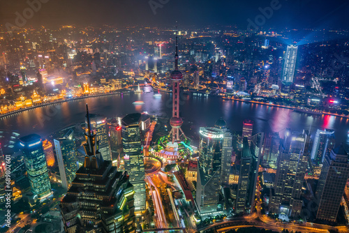 Aerial view of Shanghai skyline and financial district along Huangpu river at night, China. photo