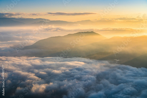 Aerial view of low clouds over mountains at sunset in Yunnan province, China. photo