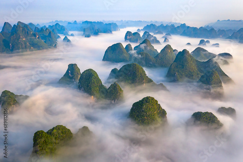 Aerial view of Guilin mountain landscape at sunrise with low clouds over the valley and fog, Guangxi, China.