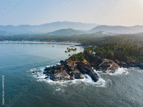 Aerial view of Palolem beach, a tropical beach with coconut trees and cliffs in south Goa, India. photo