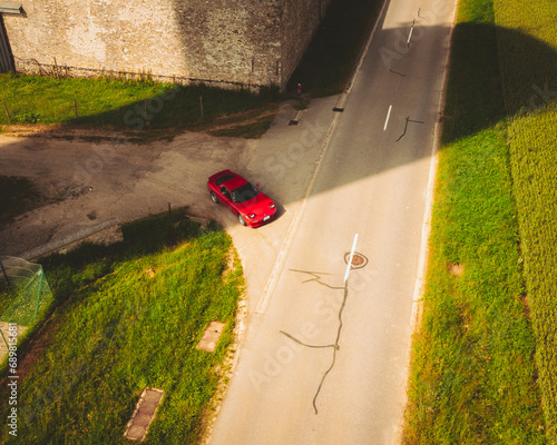 Aerial view of a Red Sport Japanese Car, Haute Vallée de Chevreuse Park, Ile de France, France.