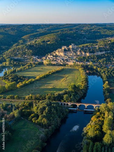 Aerial view of La Roque-Gageac village and fort castle on the hill along the Dordogne river, Nouvelle-Aquitaine, southwestern France photo