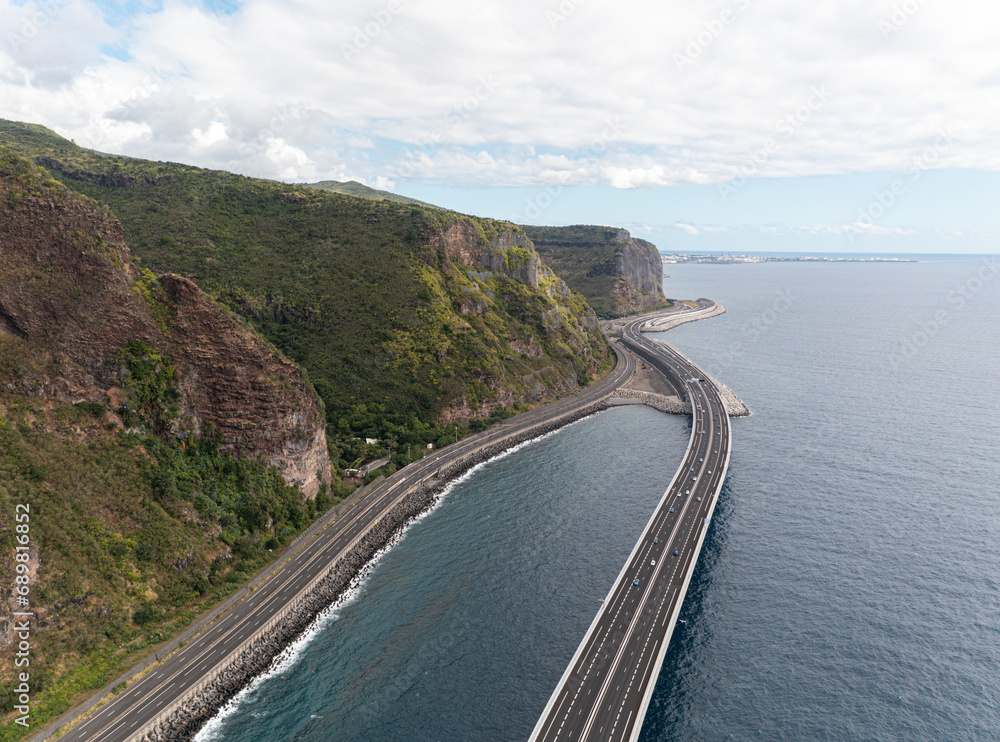 Aerial view of the new and old coastal road Route du Littoral connecting Saint Denis with La Possession, Réunion. Aerial view of the new and old coastal road Route du Littoral connecting Saint Denis with La Possession, Réunion.