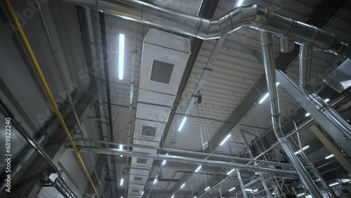 HVAC Duct Cleaning, Ventilation pipes in silver insulation material hanging from the ceiling inside new building.