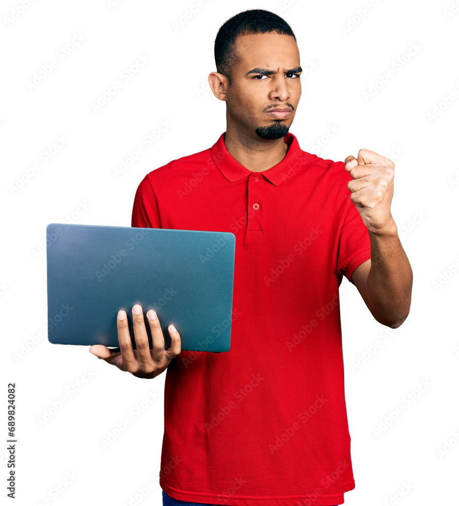 Young african american man working using computer laptop annoyed and frustrated shouting with anger, yelling crazy with anger and hand raised Young african american man working using computer laptop annoyed and frustrated shouting with anger, yelling crazy with anger and hand raised