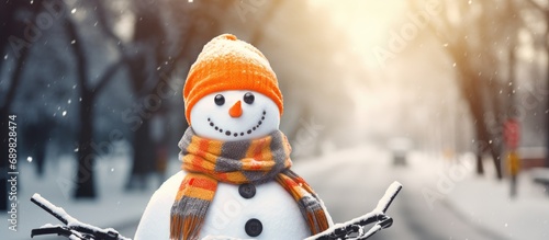 A snowman with a bright reflective vest and bicycle helmet ensures that he s safely equipped for cycling. Copyspace image. Square banner. Header for website template photo