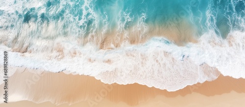 Aerial view of ocean waves washing a secluded sandy shoreline beach. Copyspace image. Square banner. Header for website template