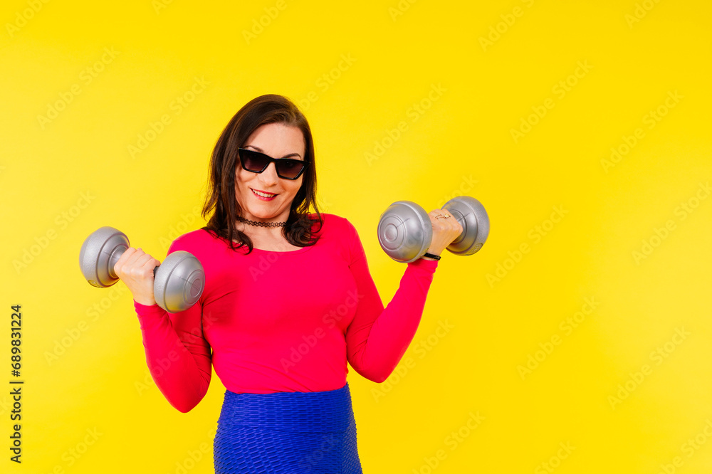 Young smiling happy chubby overweight plus size big fat fit woman warm up training hold dumbbells Young smiling happy chubby overweight plus size big fat fit woman warm up training hold dumbbells