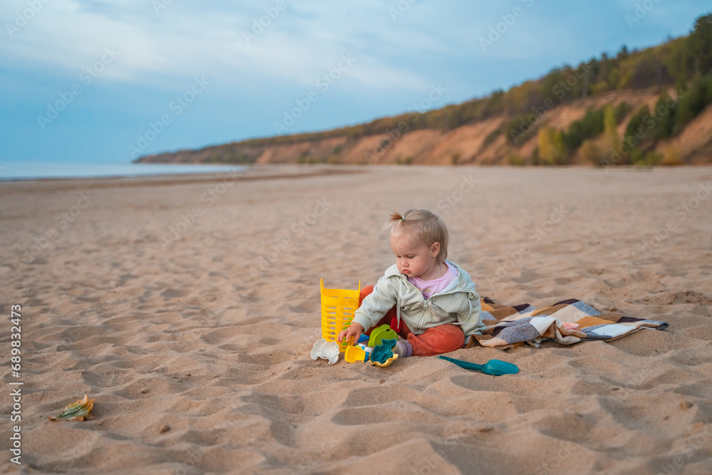 Cute baby child toddler on the beach at sunset Cute baby child toddler on the beach at sunset