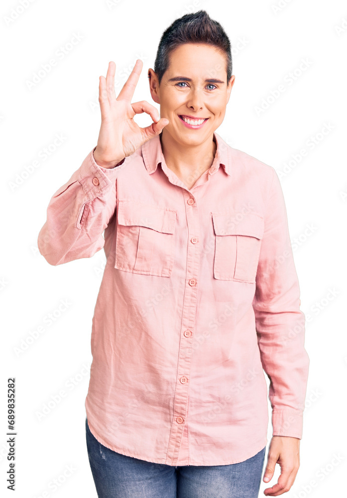 Young woman with short hair wearing casual clothes smiling positive doing ok sign with hand and fingers. successful expression. Young woman with short hair wearing casual clothes smiling positive doing ok sign with hand and fingers. successful expression.