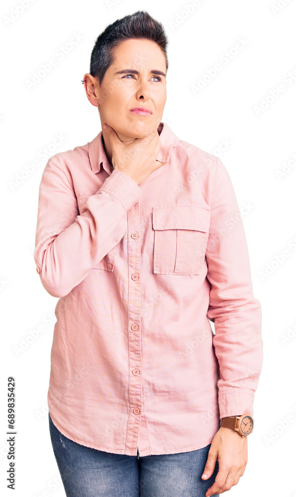 Young woman with short hair wearing casual clothes touching painful neck, sore throat for flu, clod and infection Young woman with short hair wearing casual clothes touching painful neck, sore throat for flu, clod and infection