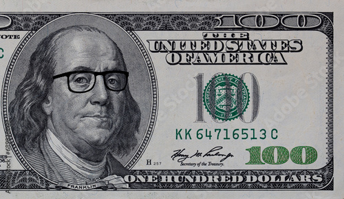 Benjamin Franklin in glasses on US 100 dollar banknote