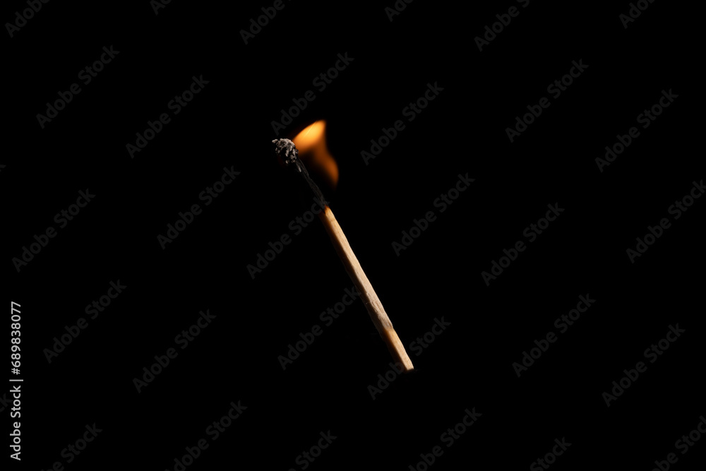 Lit falling match on a black background. Lit falling match on a black background.