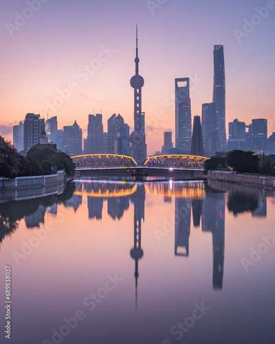 View of Shanghai skyline at sunset, view of the financial district along the Huangpu River, China. photo