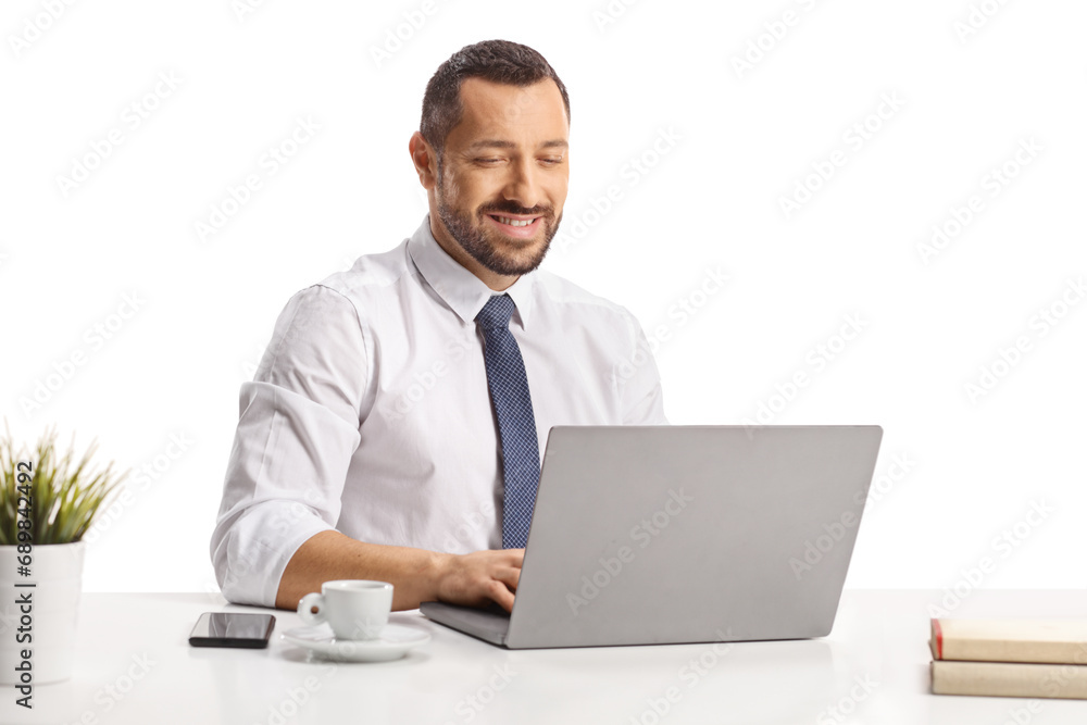 Young professional man working on a laptop computer and having a cup of espresso Young professional man working on a laptop computer and having a cup of espresso
