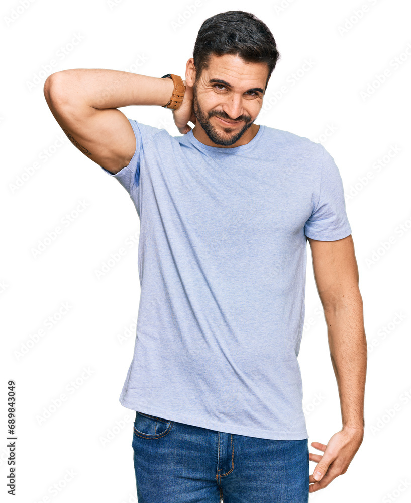 Fototapeta premium Young hispanic man wearing casual clothes suffering of neck ache injury, touching neck with hand, muscular pain