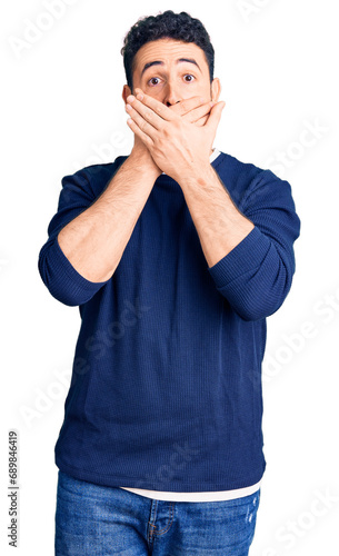 Young hispanic man wearing casual clothes shocked covering mouth with hands for mistake. secret concept.