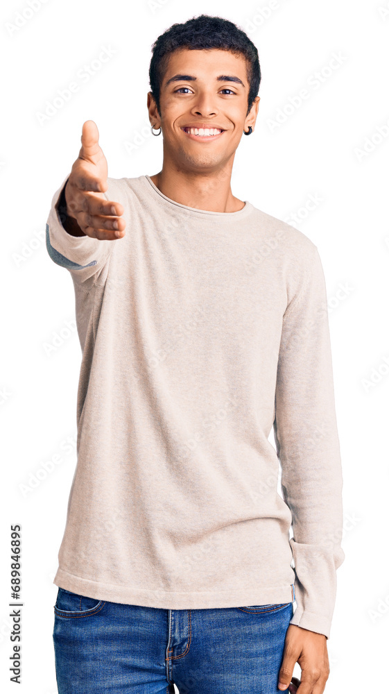 Young african amercian man wearing casual clothes smiling friendly offering handshake as greeting and welcoming. successful business. Young african amercian man wearing casual clothes smiling friendly offering handshake as greeting and welcoming. successful business.