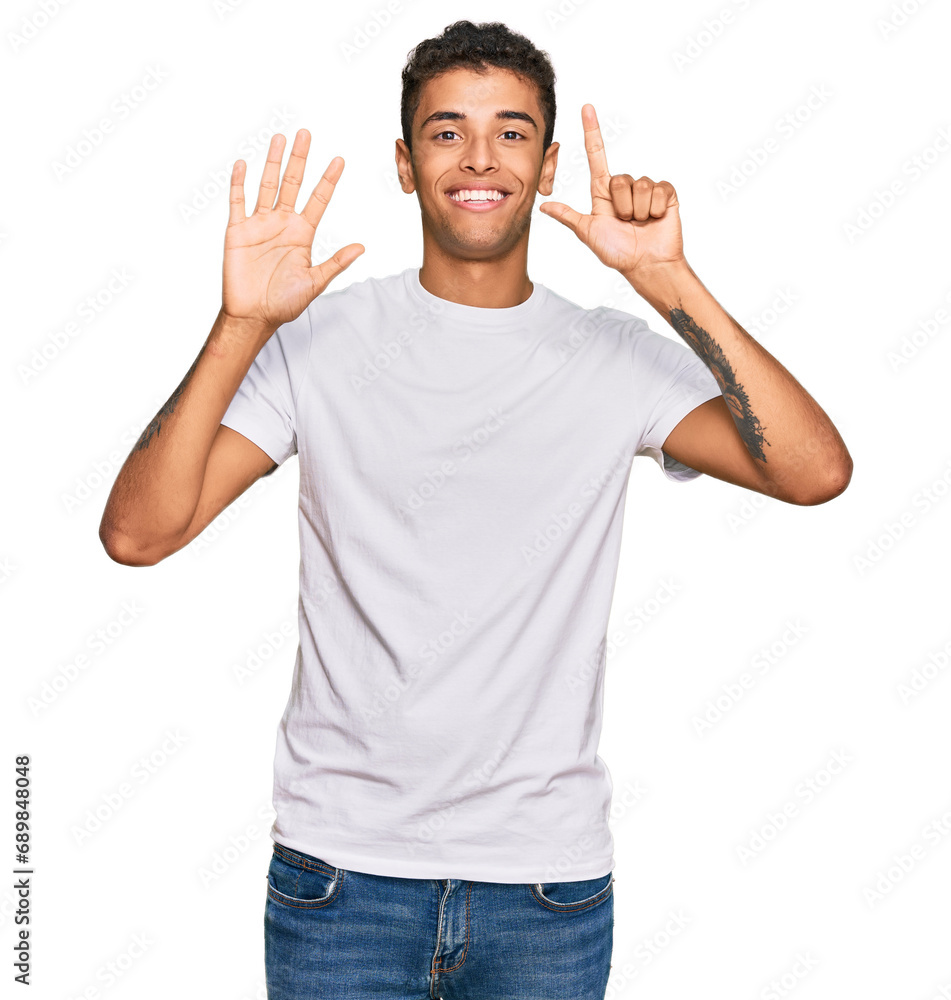 Young handsome african american man wearing casual white tshirt showing and pointing up with fingers number seven while smiling confident and happy. Young handsome african american man wearing casual white tshirt showing and pointing up with fingers number seven while smiling confident and happy.