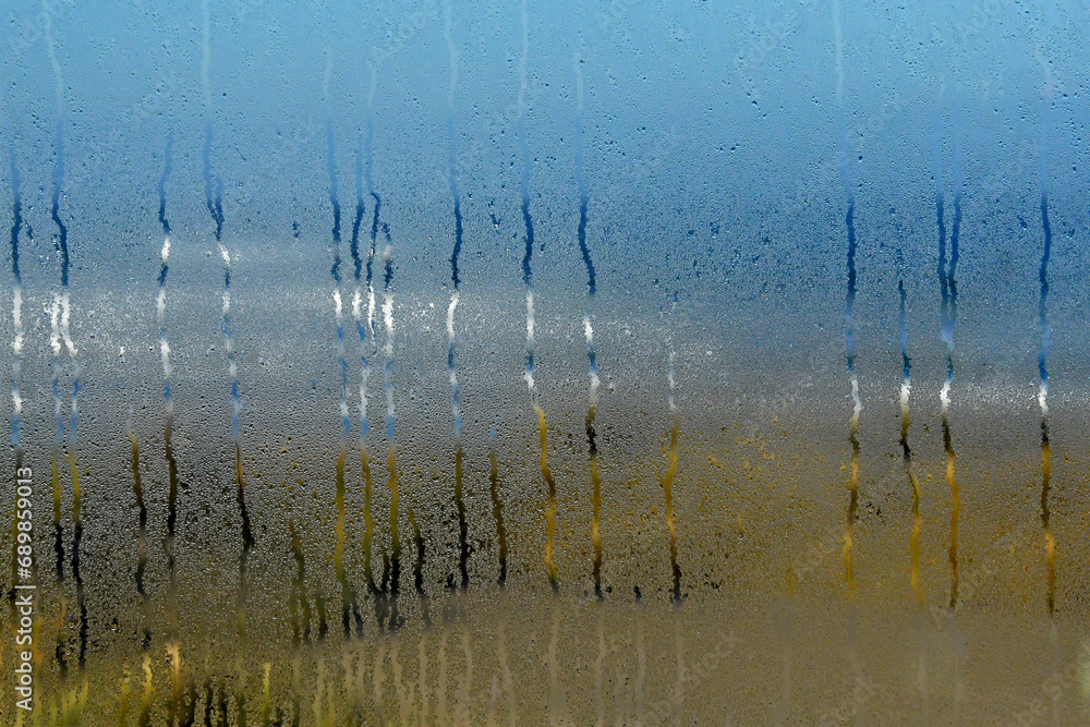 Fototapeta premium Impressionistic beach scene through condensation on window