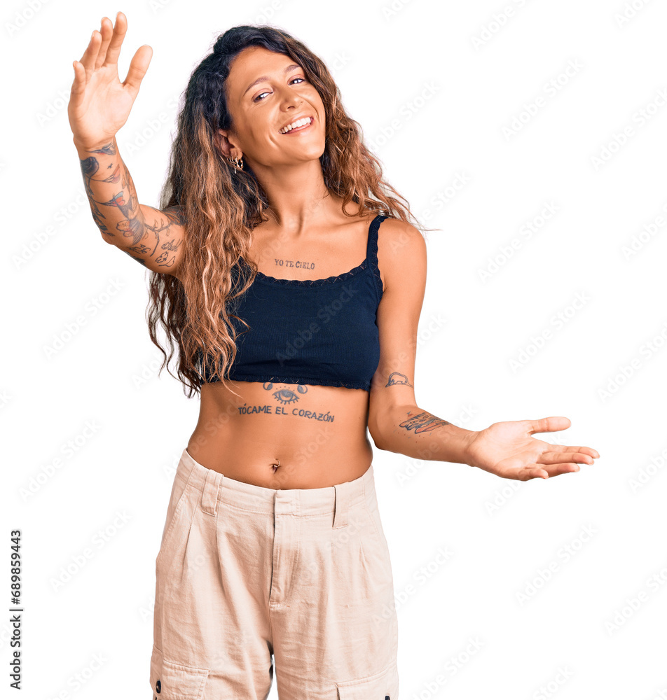 Young hispanic woman with tattoo wearing casual clothes looking at the camera smiling with open arms for hug. cheerful expression embracing happiness. Young hispanic woman with tattoo wearing casual clothes looking at the camera smiling with open arms for hug. cheerful expression embracing happiness.