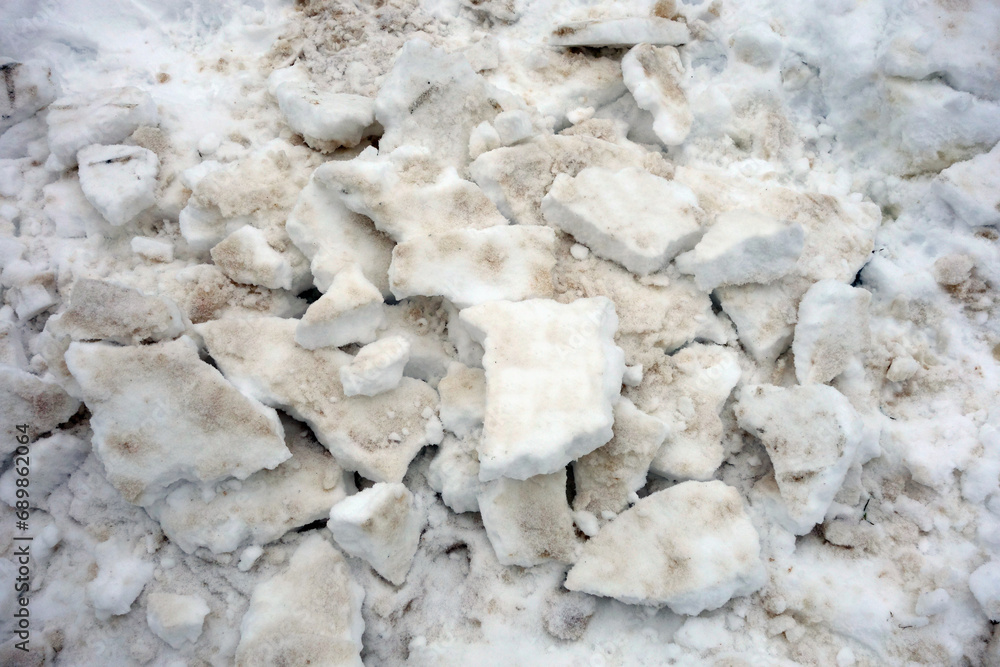 A layer of icy snow removed from the sidewalk A layer of icy snow removed from the sidewalk