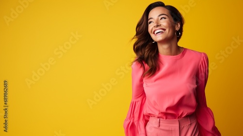 A joyful ultra beauty businesswoman, representing confidence, wearing a bright pink dress against a vibrant yellow background, smiling radiantly.