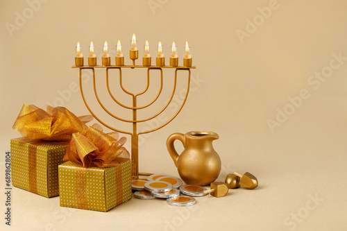 Jewish religious holiday Hanukkah with holiday Hanukkah (traditional candelabra) with donut, wooden dreidel (spinning top), oil jug.