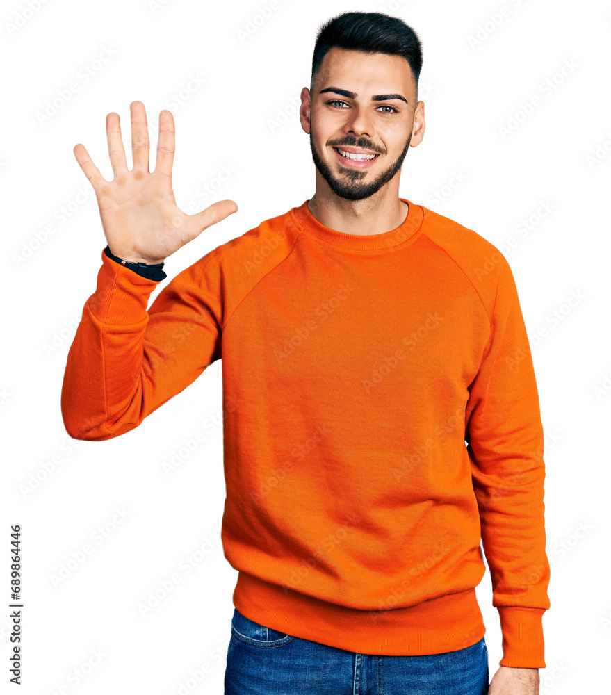 Fototapeta premium Young hispanic man with beard wearing casual orange sweater showing and pointing up with fingers number five while smiling confident and happy.