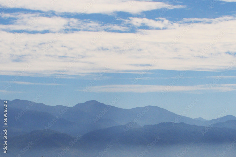 Obraz premium clouds in the mountains hazy scenery background