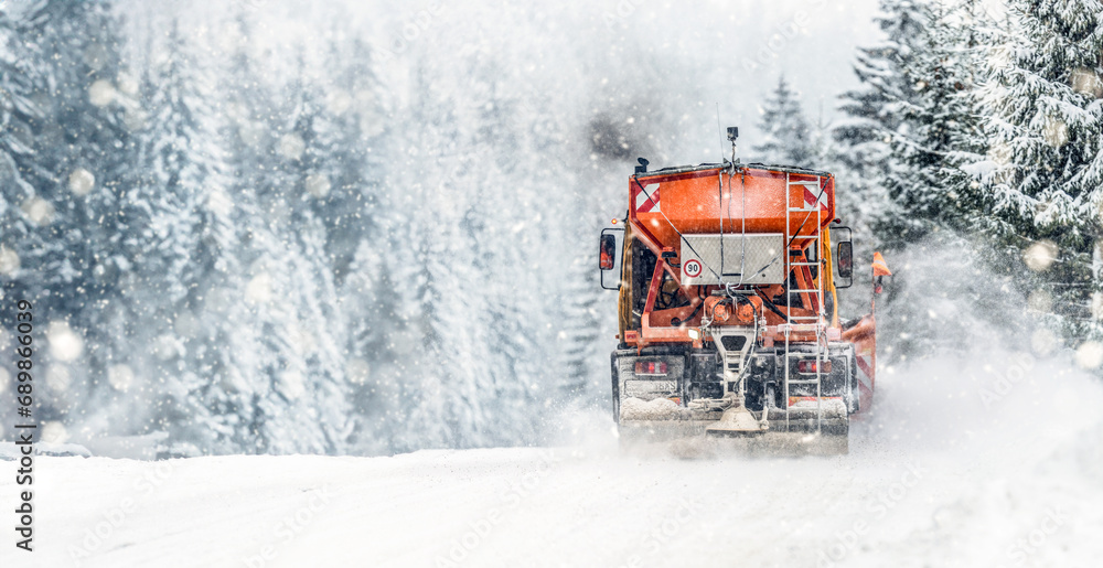 Snow plow on highway salting road . Orange truck deicing street. Maintenance winter gritter vehicle wide panorama or banner Snow plow on highway salting road . Orange truck deicing street. Maintenance winter gritter vehicle wide panorama or banner