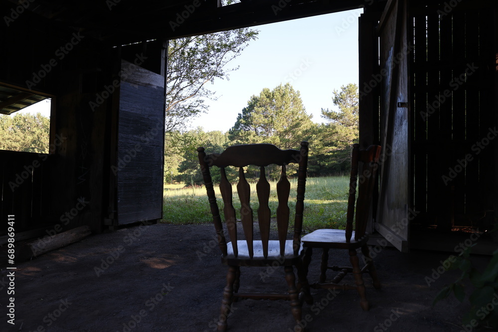 Barn and Rocking Chairs in field 