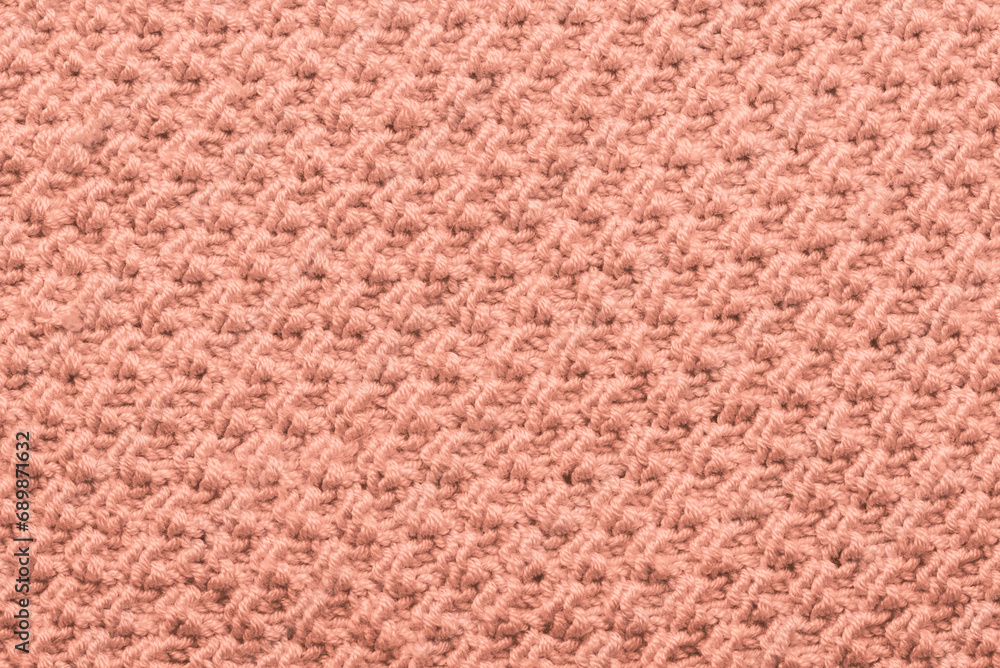 Trendy color of 2024 Year Peach Fuzz. Knit texture of wool knitted fabric with pattern background. Place for text. close up of abstract fabric texture Trendy color of 2024 Year Peach Fuzz. Knit texture of wool knitted fabric with pattern background. Place for text. close up of abstract fabric texture