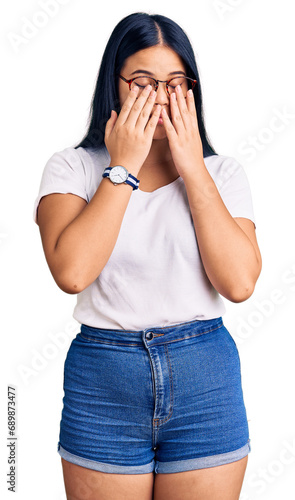 Young beautiful asian girl wearing casual clothes and glasses rubbing eyes for fatigue and headache, sleepy and tired expression. vision problem