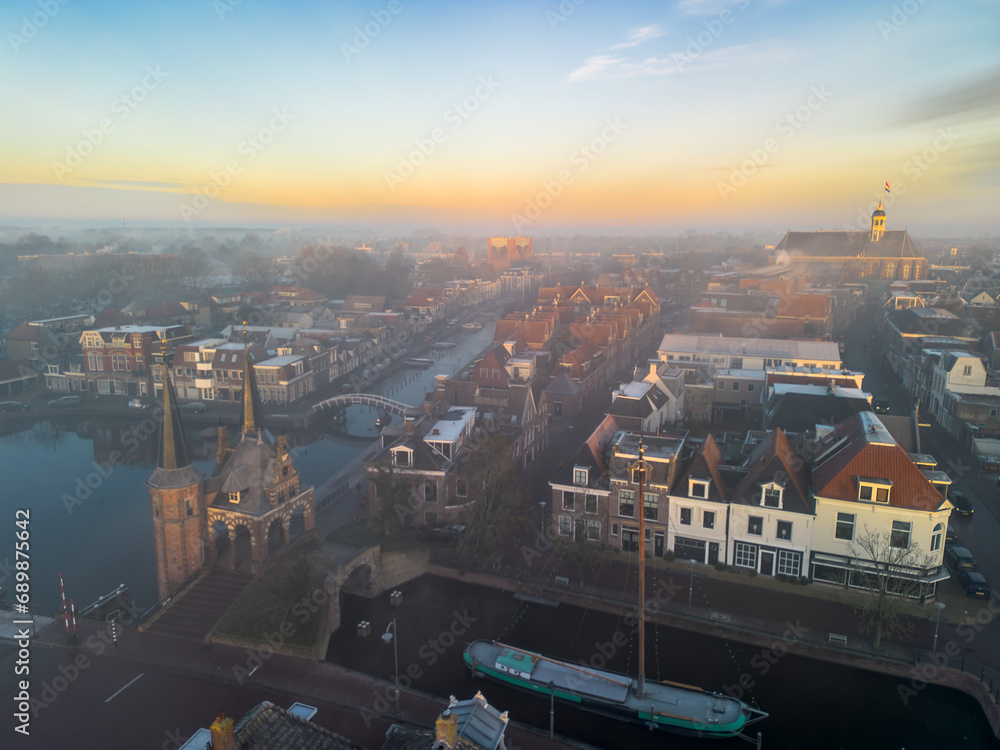 Fototapeta premium Drone view across city of Sneek with historic, iconic Watergate, waterpoort