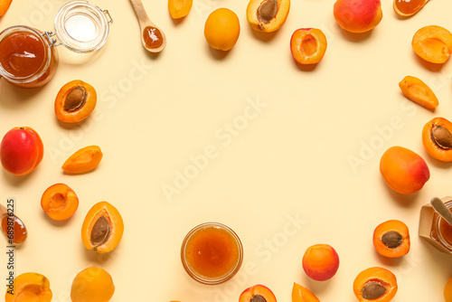 Frame made of jar with sweet apricot jam and fruits on yellow background