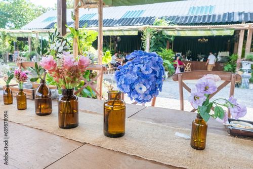 Photography Blue Hydrangea flowers in vase on wooden table at outdoor restaurant