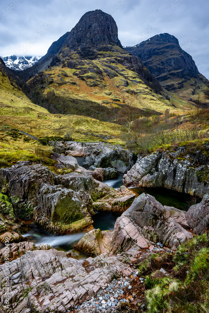 Beautiful waterfall and rapids with the Three Sisters Mountains in Glencoe, the Scottish Highlands, Scotland UK Beautiful waterfall and rapids with the Three Sisters Mountains in Glencoe, the Scottish Highlands, Scotland UK