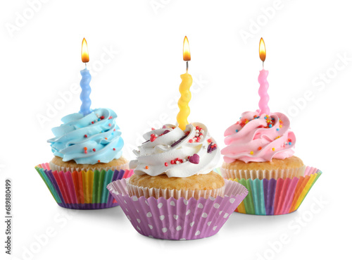 Delicious birthday cupcakes with burning candles on white background