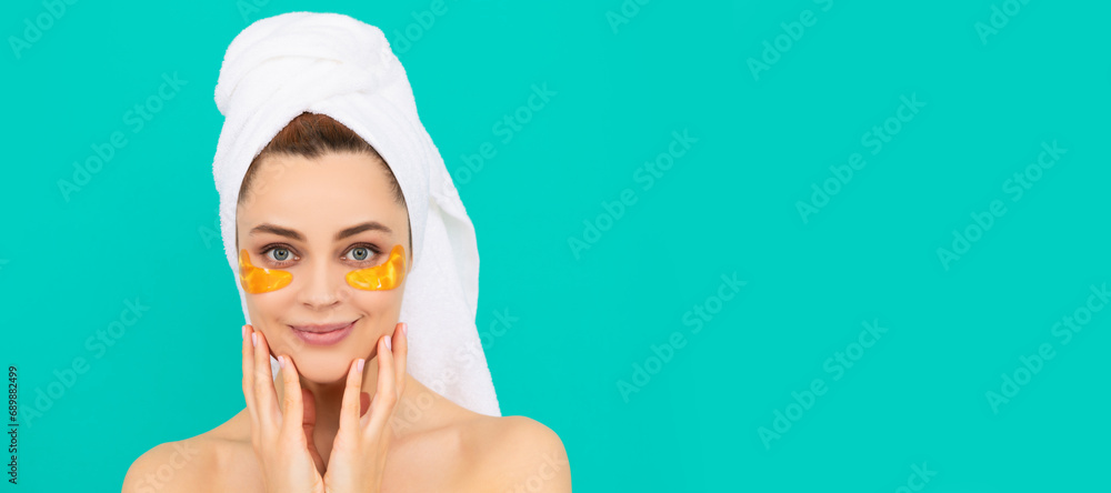 cheerful woman has collagen golden eye patches on face with towel. Beautiful woman isolated face portrait, banner with mock up copy space. cheerful woman has collagen golden eye patches on face with towel. Beautiful woman isolated face portrait, banner with mock up copy space.