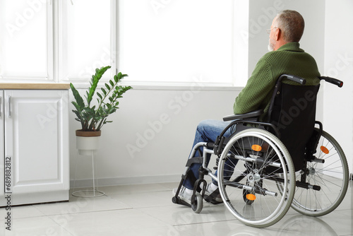 Senior man in wheelchair at home